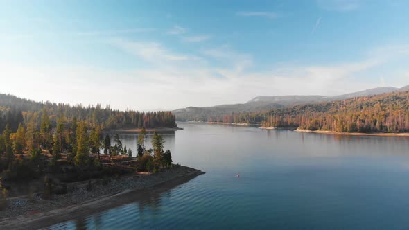 Aerial shot of beautiful blue alpine lake taken at sunset.