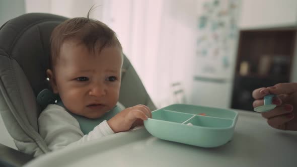 Parents Feed the Child with Banana Slices