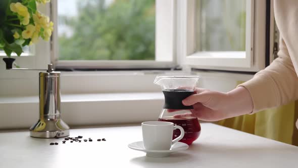 Unrecognisable Woman Pouring a Hot Coffee From Glass Coffee Maker