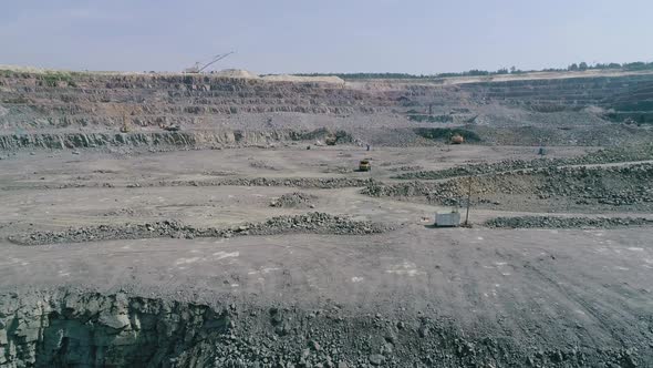 Mining Dump Trucks in Large Granite Open Pit Mine.