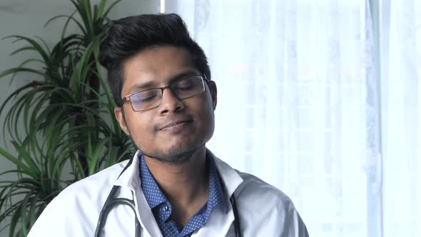 Young Asian Doctor Talking To Camera in Video Chat.