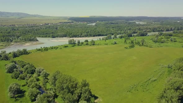 Aerial: Flying Back Over the Fields, Among the Highlands. View of the Islands of the Mountain River