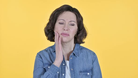 Old Woman with Toothache on Yellow Background