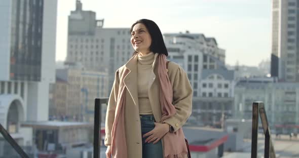 Confident Brunette Caucasian Woman Standing on City Street and Looking Away