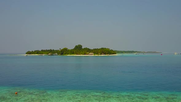 Drone seascape of tourist beach break by blue lagoon and sand background