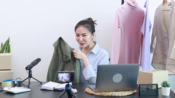 Asian woman selling clothes online