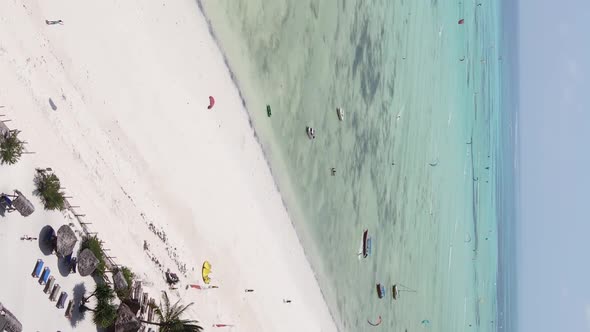 Vertical Video Kitesurfing Near the Shore of Zanzibar Tanzania Aerial View