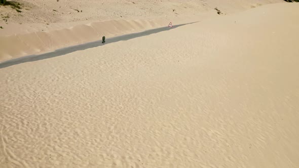 Infinite sand at dune of Valdevaqueros flight into desert road