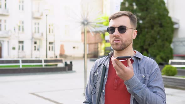 Blind Man with Disability Using Digital Assistant and Ease of Access Functions on Smartphone