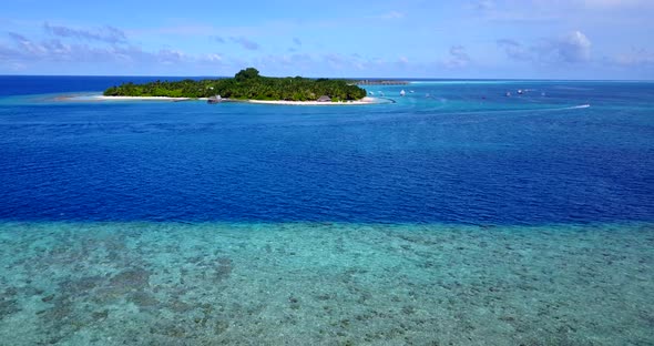 Beautiful drone tourism shot of a sunshine white sandy paradise beach and blue sea background 