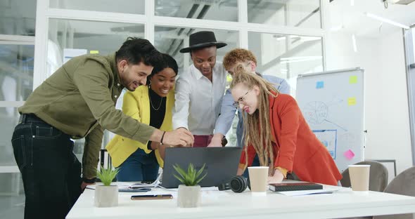 Team which Getted Good News On Laptop Screen and Celebrating Victory After Ending Joint Project