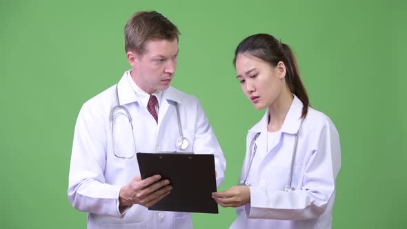 Multi-ethnic Couple Doctors Having Discussion Together