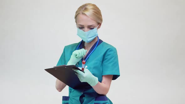 Medical Doctor Nurse Woman Wearing Protective Mask and - Holding Blood Test Tube and Plane Table