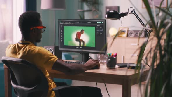 African American Man Editing Video with Chromakey Background
