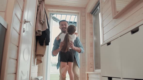 Happy Father Hugging Girl after Returning Home