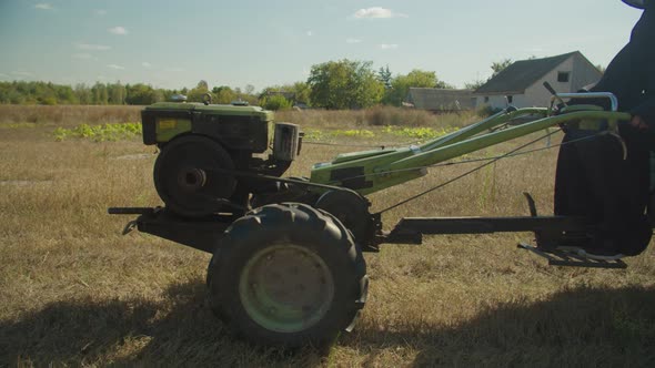 People in Halloween Costumes Riding on Mini Tractor