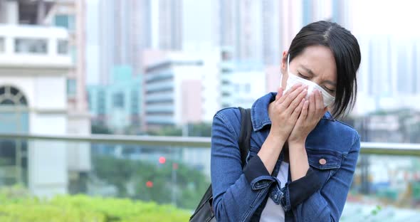 Woman sneeze and wearing face mask