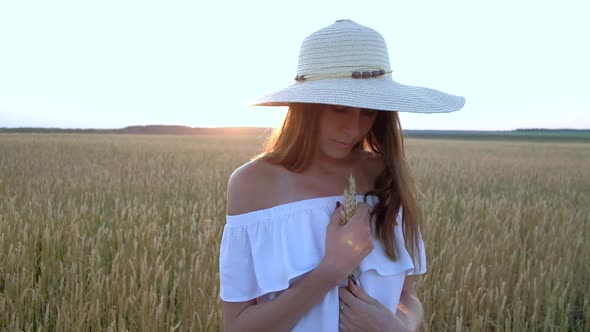 Amazing Portrait of Beautiful Woman Standing in Field of Ripe Golden Wheat