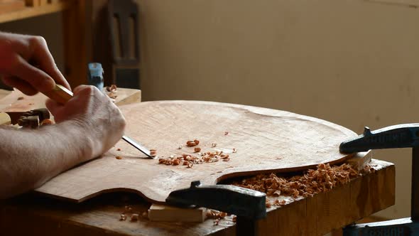 Luthier Carving a Guitar