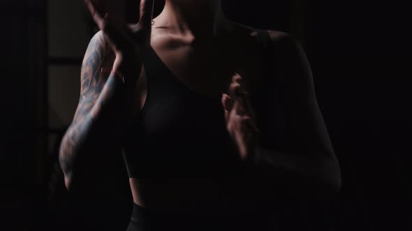 A Tattooed Woman Showing Karate Fighting Hands Moves
