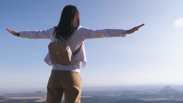 Successful Girl Hiker Open Arms in the Sky After Hiking To Mountain Top Summit Above the Clouds.