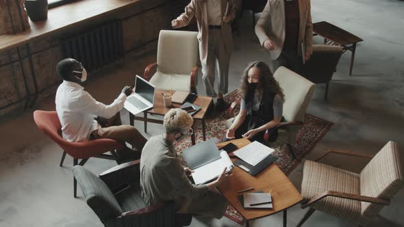 Top-View of Coworkers in Face Masks Arriving at Meeting