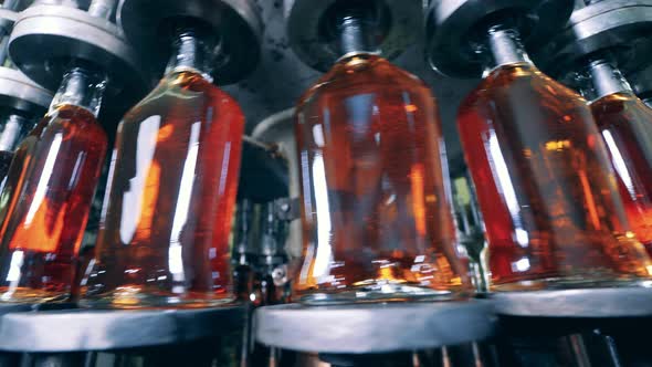 Metal Conveyor Is Revolving with Liquor Bottles in It