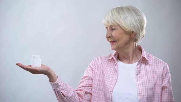 Smiling Aged Female Holding Pills, Health Care in Old Age, Illness Treatment