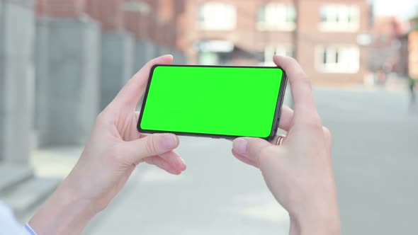 Woman Watching Smartphone with Green Chroma Screen