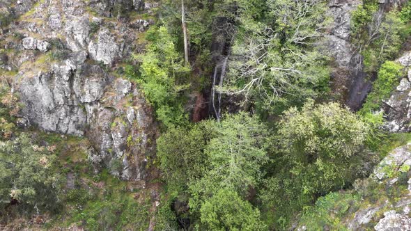 Barbelote Waterfall in Serra de Monchique in Faro, Algarve, Portugal - High angle Orbit Aerial shot