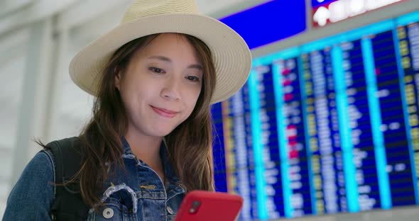 Woman use of mobile phone inside airport