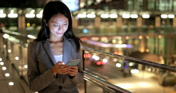 Woman using cellphone at night 