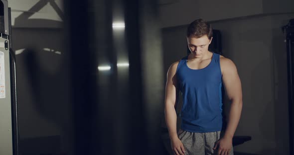 A Man Makes Stretching the Neck and Circular Moves of the Head in Gym