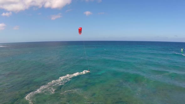 Aerial view of a man kitesurfing in Hawaii