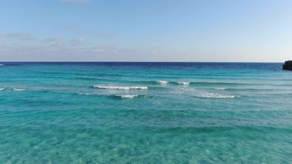 Turquoise Foamy Waves Rolling To Camera. Wide Shot Seascape of Mediterranean Resort on Cyprus