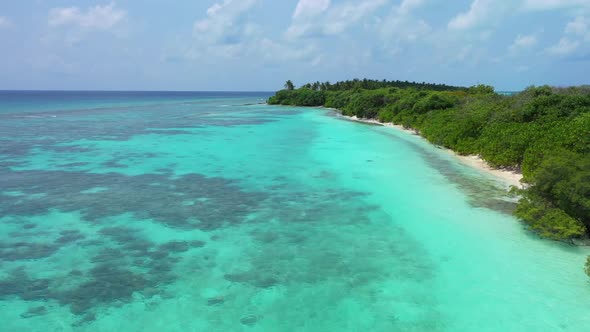 Aerial panorama of perfect island beach holiday by clear ocean with white sand background of a daytr