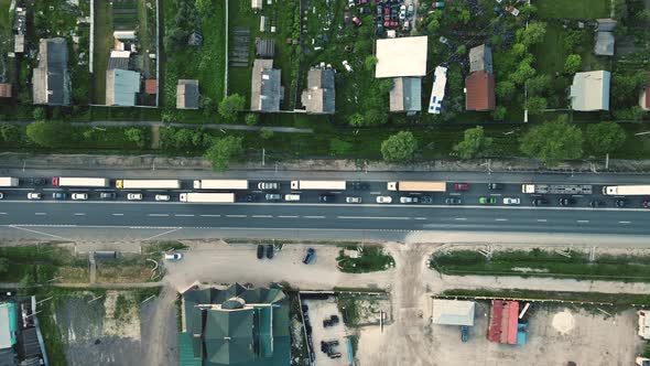 Trucks and Cars Stand in a Traffic Jam at an Intersection Bird'seye View