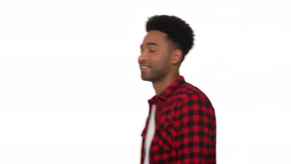 Portrait of Young Africanamerican Man in Red Plaid Shirt Appearing in Front of Camera Posing with