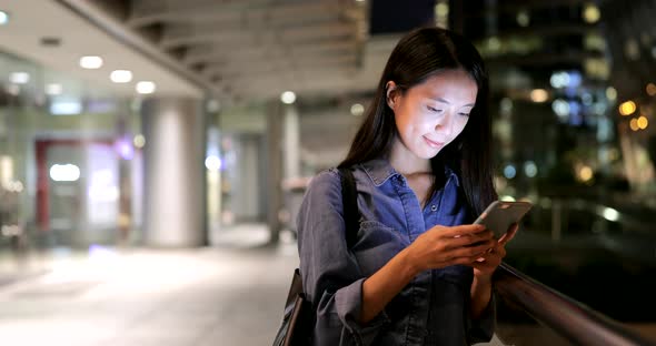 Woman looking at mobile phone in Hong Kong 