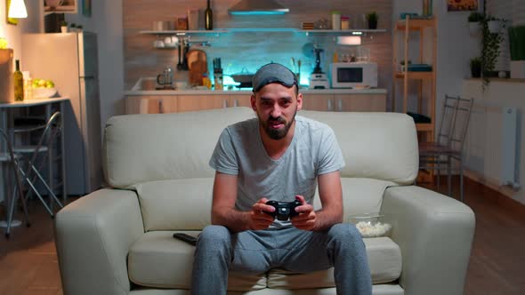 Upset Pro Gamer Sitting in Front of Television Losing Soccer Video Games