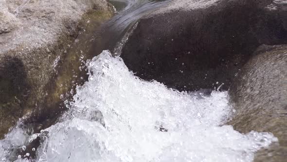 Close Up of Flowing Water Splash From Mountain River on Summer Day