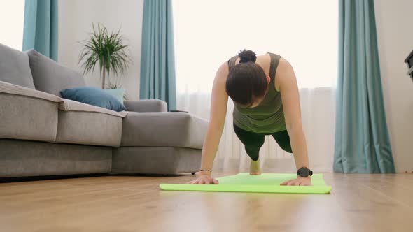 Woman Performs Fitness Exercises at Home