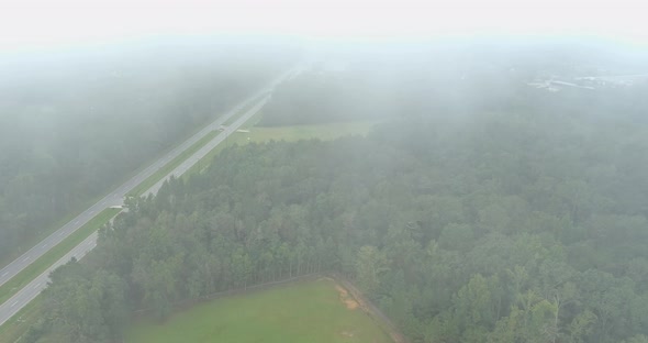 Aerial View Beautiful Early Morning with Low Hanging Fog Looking Over a Meadow Near Highway US 43In