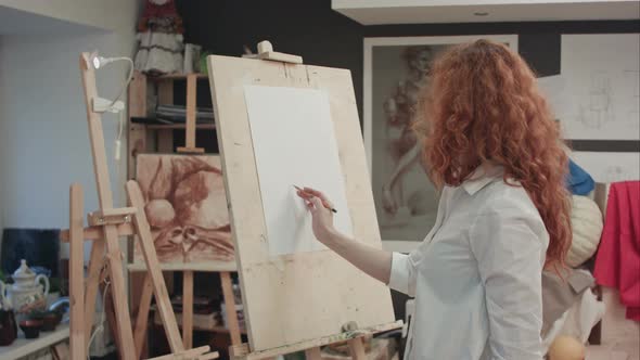 Female Student Working on a New Painting in Art Class