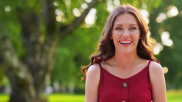 Portrait of Happy Smiling Woman at Summer Park