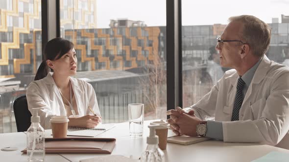 Two Doctors Talking during Medical Conference