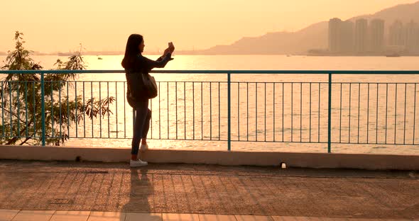 Woman look at the sea under sunset