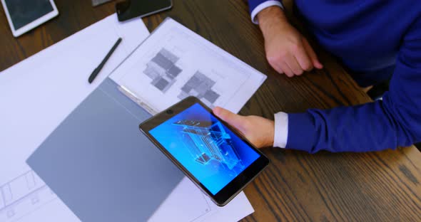 Executive using digital tablet on table in conference room at office 