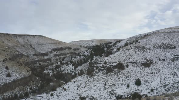 Slow tracking sideways shot of snowy canyon