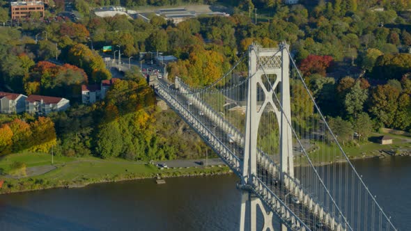 Aerial of Mid-Hudson Bridge and town amidst autumn trees at distance